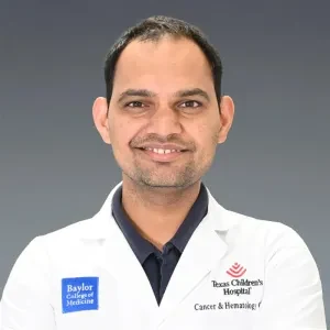 Shubham Singh, Principal Investigator — wearing a white lab coat with Baylor College of Medicine and Texas Children's Hospital badges